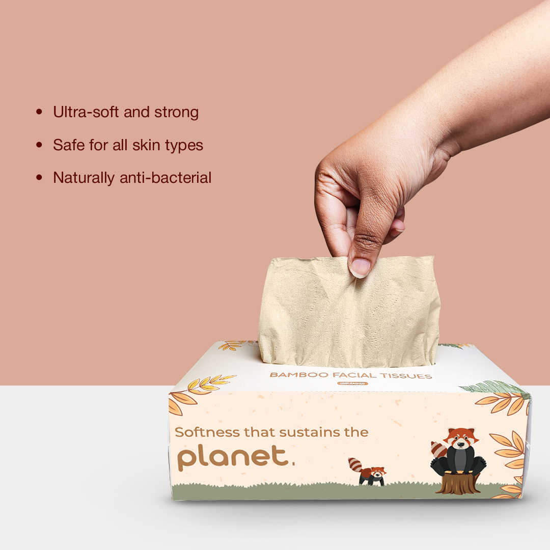 A hand taking out bamboo facial tissue with a text displaying features like 0 anti-bacterial properties, safe for skin, and ultra-softness.