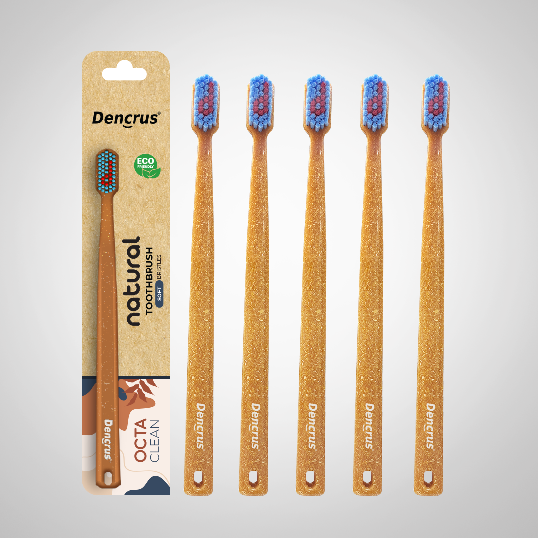 Bamboo toothbrushes with blue and red bristles, packaged in a cardboard casing with 'dencrus' and 'natural octa clean' branding.