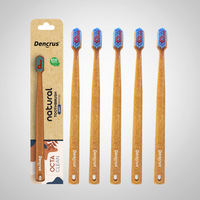 Bamboo toothbrushes with blue and red bristles, packaged in a cardboard casing with 'dencrus' and 'natural octa clean' branding.