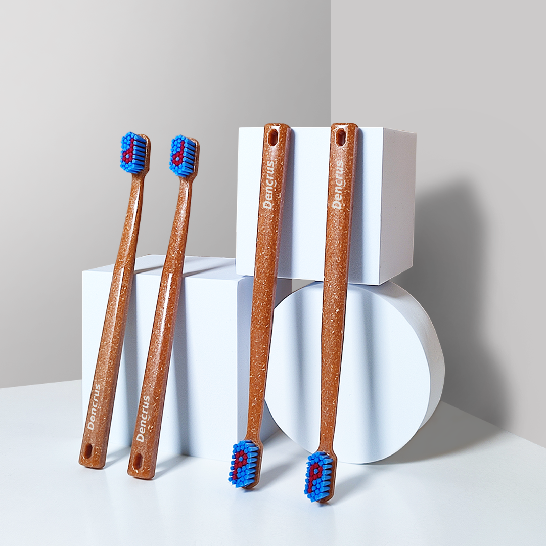 4 bamboo toothbrush with 2 of them placed upside down. The background is white.