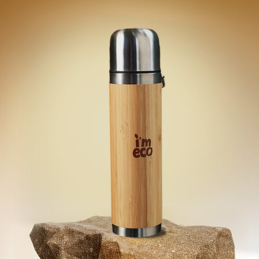 IMECO leakproof bamboo thermos flask is placed on a rock.