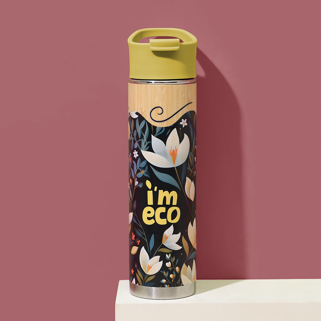 A bamboo printed water bottle with a yellow cap labelled IMECO placed on a white table and pink background.