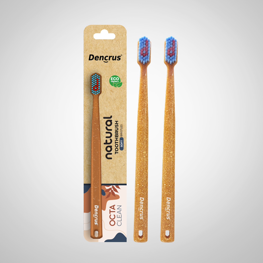 Bamboo toothbrushes with blue and red bristles, packaged in a cardboard casing with 'dencrus' and 'natural octa clean' branding.