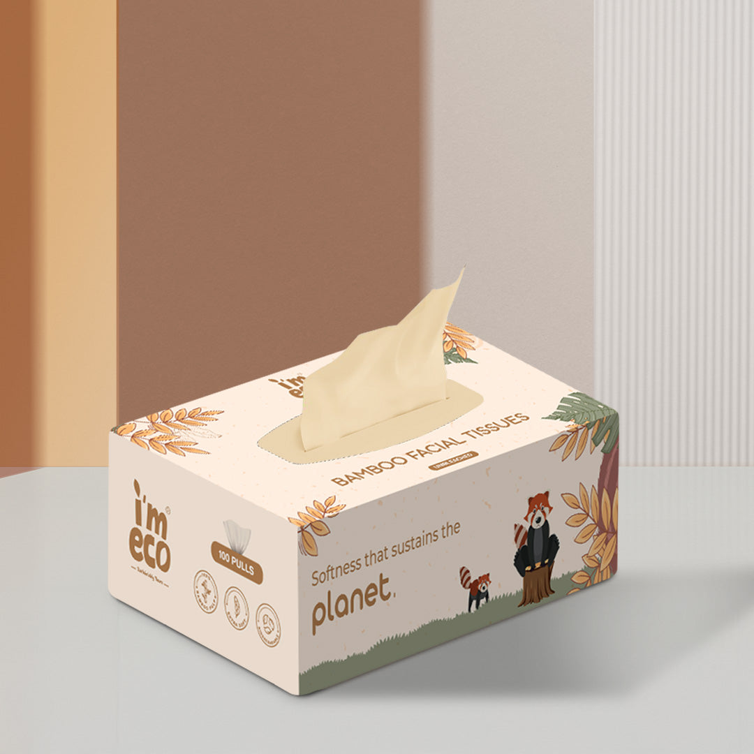 A box of bamboo facial tissues with one pull out visible. The box is white with a cartoon illustration related to sustainability.