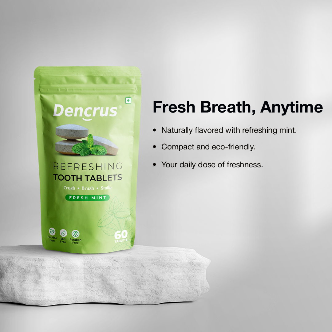 A package of Dencrus Fresh Mint tooth tablets on a textured white stone against a white background highlighting the key features