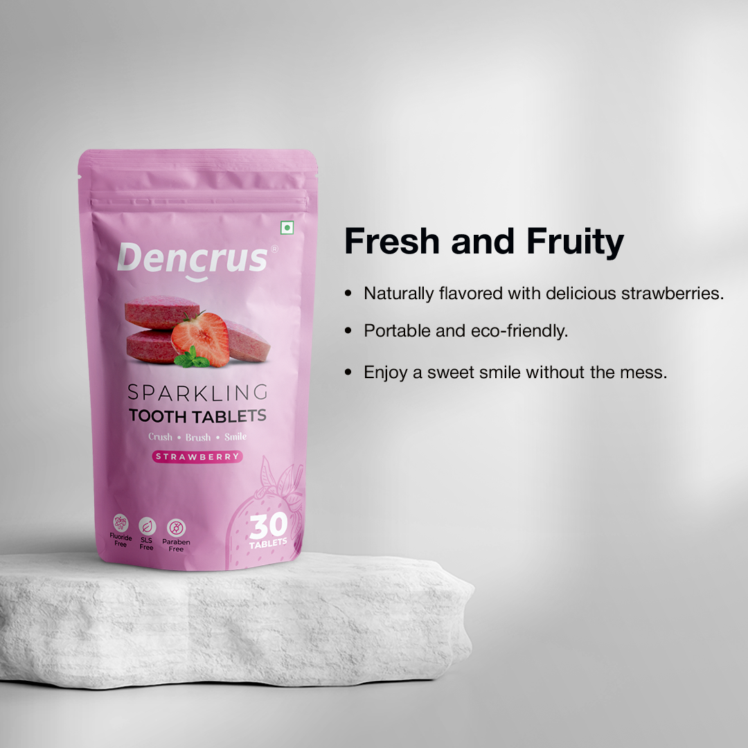 Package of Dencrus Sparkling Strawberry tooth tablets placed on a rounded white stone against a white background highlighting all the key features