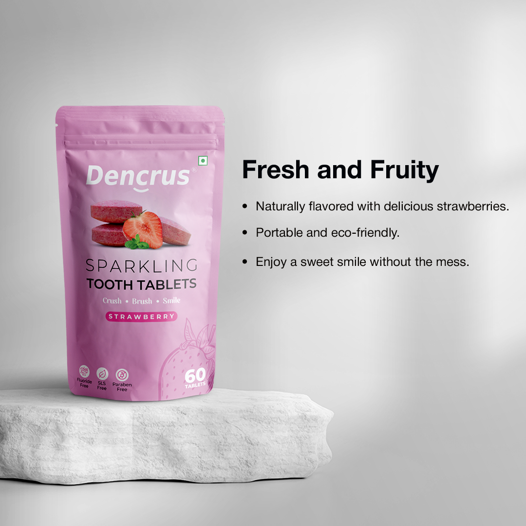 A package of Dencrus Sparkling Starwberry tooth tablets placed on rounded stone against a white background