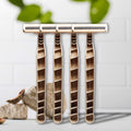 Set of four Shaveco bamboo husk razors on a white background with greenery in the background.