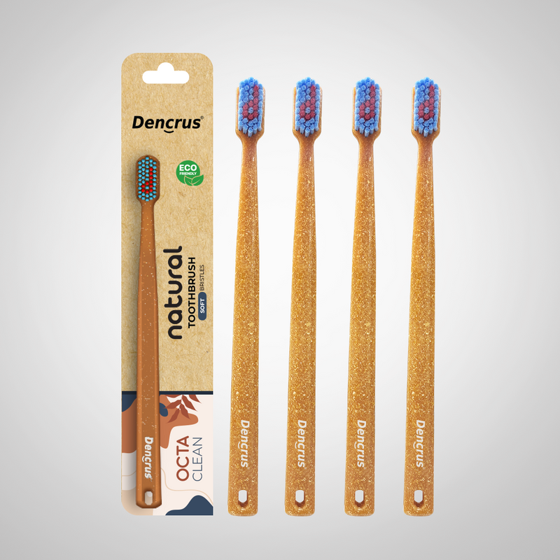 Bamboo toothbrushes with blue and red bristles, packaged in a cardboard casing with 'dencrus' and 'natural octa clean' branding.