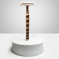 A Shaveco bamboo husk razor is placed on a white circular box with white background. It comes with 3 blade precision.