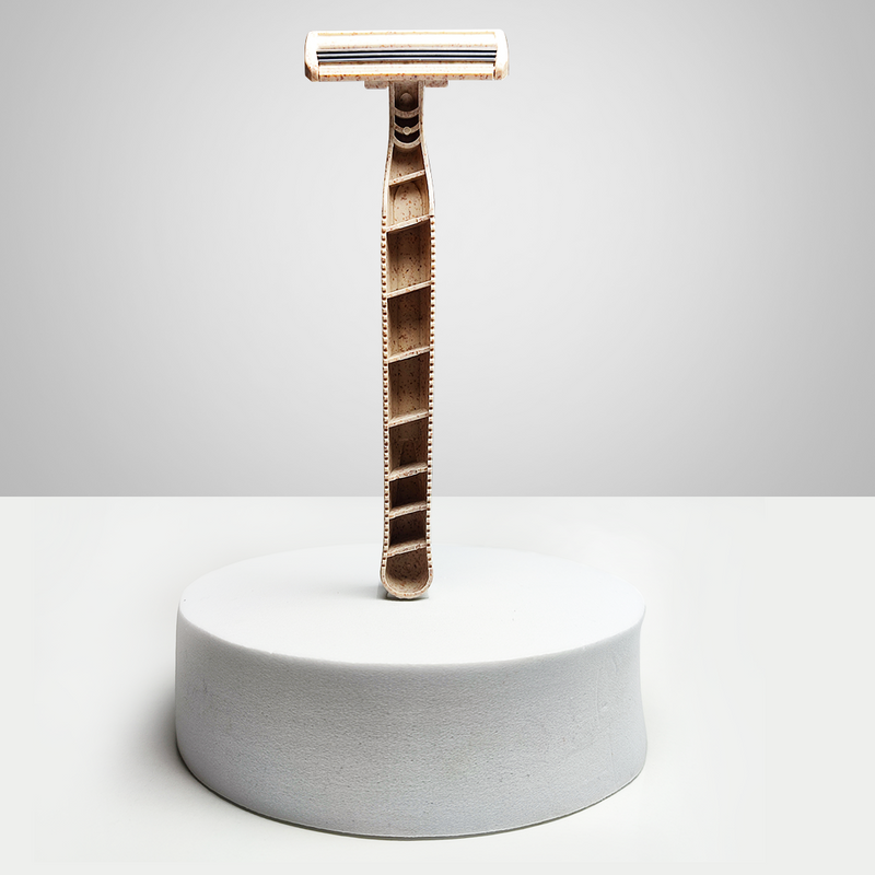 A Shaveco bamboo husk razor is placed on a white circular box with white background. It comes with 3 blade precision.