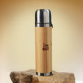 IMECO leakproof bamboo thermos flask is placed on a rock.