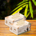 2 boxes of bamboo facial tissues are placed on a wooden base with a part of tissue shown.