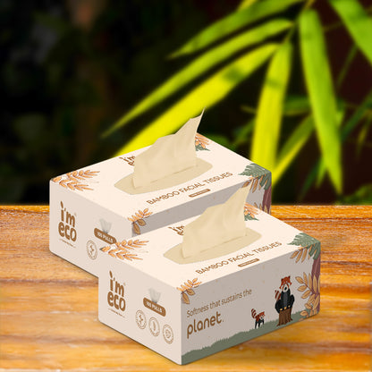 2 boxes of bamboo facial tissues are placed on a wooden base with a part of tissue shown.