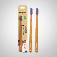 Bamboo toothbrushes with blue and red bristles, packaged in a cardboard casing with 'dencrus' and 'natural octa clean' branding.