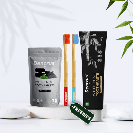 Dencrus dental care products including charcoal toothpaste, charcoal tablets, and toothbrushes on a white background.