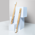 Two Dencrus Bamboo NANO Toothbrush against white building blocks and placed in a white background
