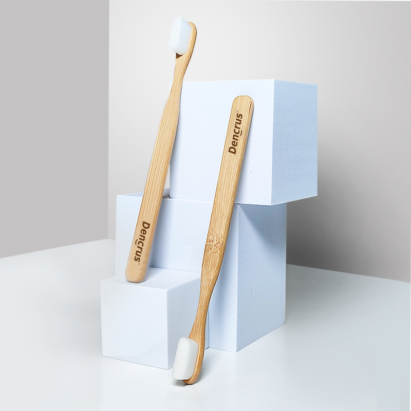 Two Dencrus Bamboo NANO Toothbrush against white building blocks and placed in a white background