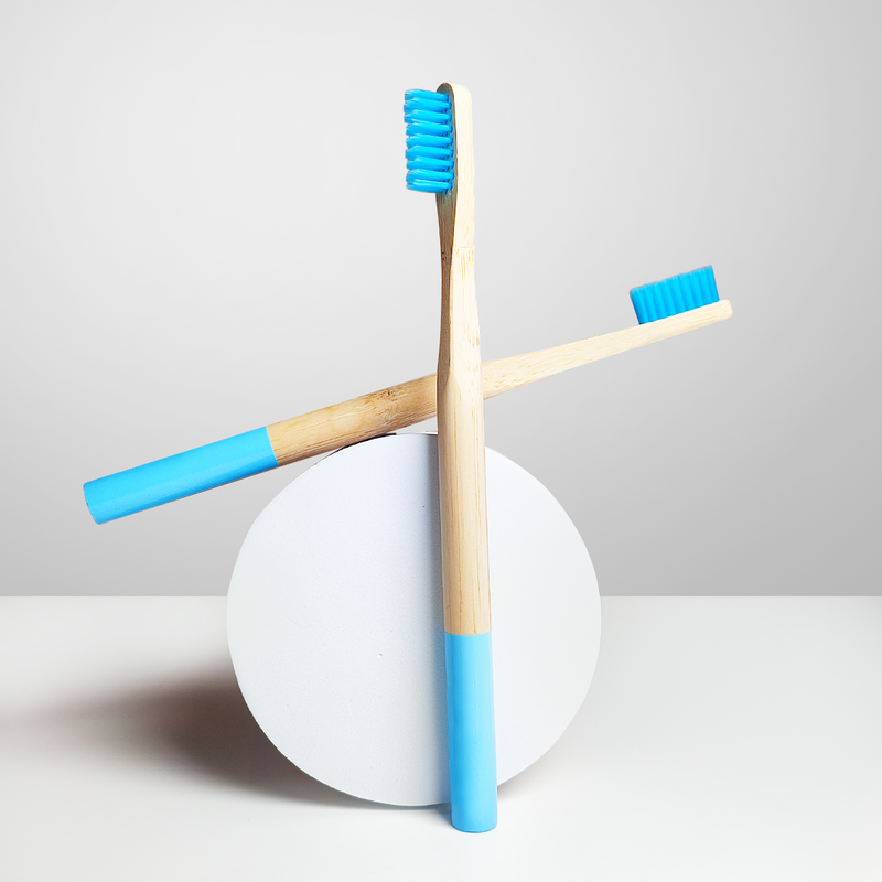 Two Dencrus ORBY Plus toothbrushes against a white background on a round surface