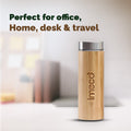 IMECO Bamboo Flat lid water bottle with stainless steel lid on a blurred office background, featuring the brand 'imeco'.