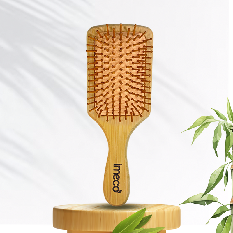 IMECO Bamboo hairbrush with 'imeco' branding on a white background with green leaves.