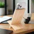 IMECO Bamboo Mobile Stand where an iPhone is placed and both of them are placed on wooden surface and in the background an office desk is visible 