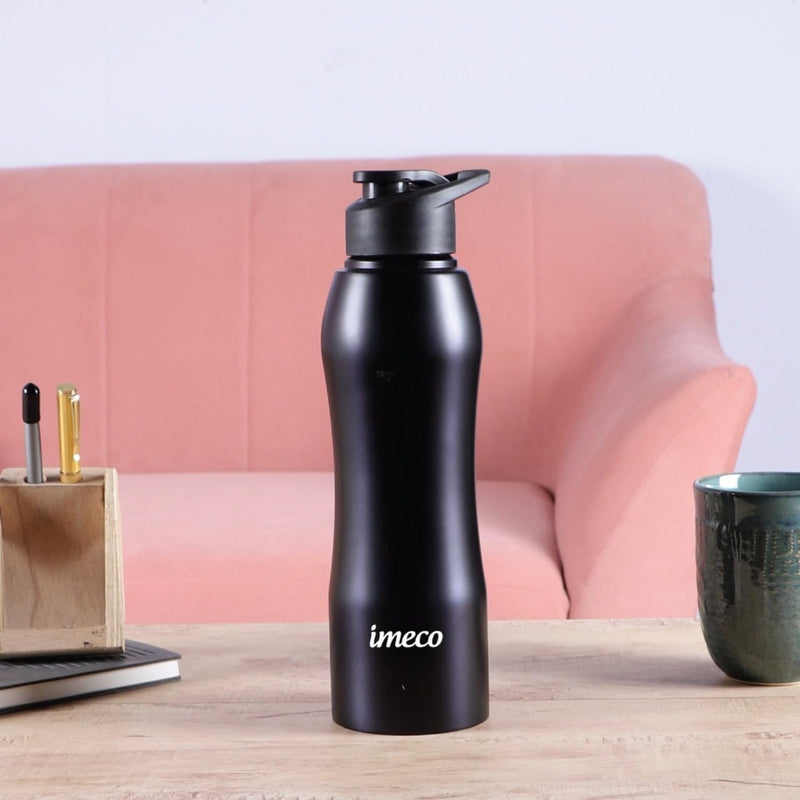 IMECO Stainless Steel water bottle on a wooden surface against a pink sofa showcasing a pen stand and a container