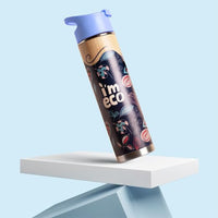 imeco bamboo water bottle with purple cap on a white platform against a light blue background